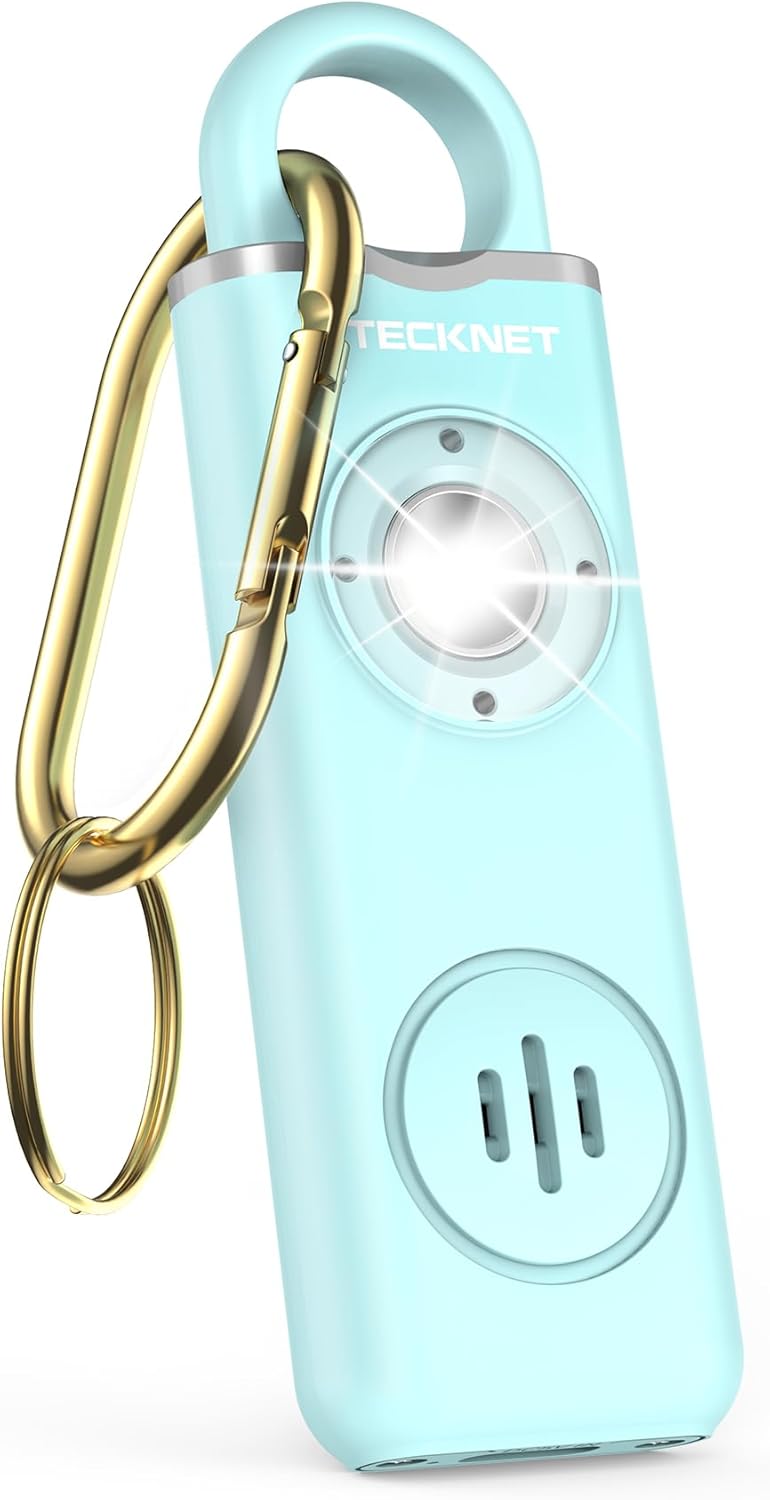 A light turquoise TECKNET rechargeable personal safety alarm with a sleek rectangular design and metallic silver top. The device features a bright circular LED light in the center, a speaker grille below, and a gold carabiner clip with a keyring attached for easy carrying. The compact, modern look highlights its dual functionality as a 130 dB siren and SOS strobe light, ideal for women, kids, and the elderly.