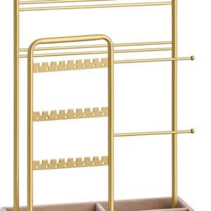 A pale gold metal jewelry stand with a white rectangular base and beige velvet lining. The organizer features multiple tiers: a top row of hooks for necklaces, two horizontal bars for bracelets, a central section with perforated rows for earrings, and a divided tray at the bottom for rings and small accessories. The elegant minimalist design highlights its functionality and stylish presentation for displaying jewelry.