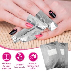A close-up of hands with pink and black nail polish, each nail featuring a small contrasting dot near the cuticle. Several fingers are wrapped in shiny silver foil nail remover wraps. Below the hands, three icons highlight product benefits: “Not easy to tear when use,” “Doesn’t harm nails,” and “Easy to remove nail polish.” Two foil wraps with white absorbent pads are shown beside the icons, illustrating the product’s design and purpose.