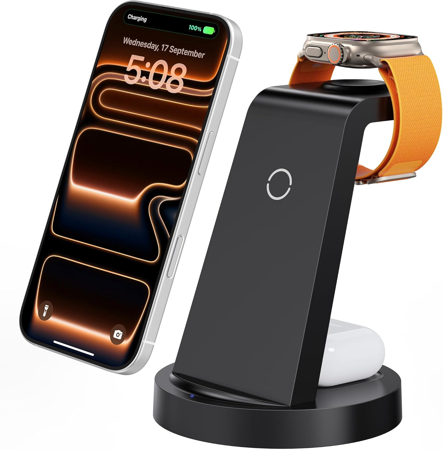 A sleek black 3‑in‑1 wireless charging station holds an iPhone, Apple Watch, and AirPods. The iPhone stands vertically on the left, showing a glowing orange abstract wallpaper and a full battery at 100%. The Apple Watch with an orange band rests on the upper arm of the stand, while the white AirPods case sits at the base, illustrating simultaneous charging for all devices.