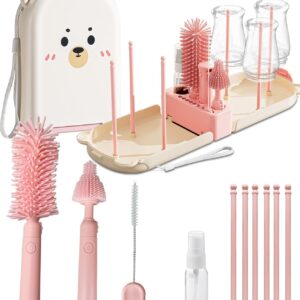A pink and white baby bottle cleaning kit featuring a bear‑face carrying case, foldable drying rack with upright posts holding clear bottles, and multiple cleaning tools including silicone brushes, a wire brush, a spray bottle, and small accessories—all neatly arranged for travel and baby care convenience.
