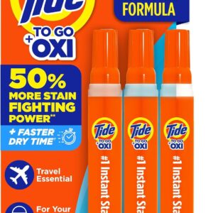 Retail package of three Tide To Go + Oxi instant stain remover pens with orange caps and blue labels, displayed vertically on bright orange and blue packaging. Text highlights enhanced formula, 50% more stain‑fighting power, faster dry time, and travel convenience