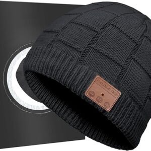 A black knitted Bluetooth beanie hat with a textured square pattern and ribbed edge, displayed in front of a sleek black gift box. The beanie features a brown leather patch on the front embossed with “FULLLIGHT TECH” and three control symbols (minus, circle, plus), indicating built‑in headphone functionality. The modern design highlights its combination of warmth, style, and wireless audio technology—ideal as a unique tech gift or stocking stuffer.